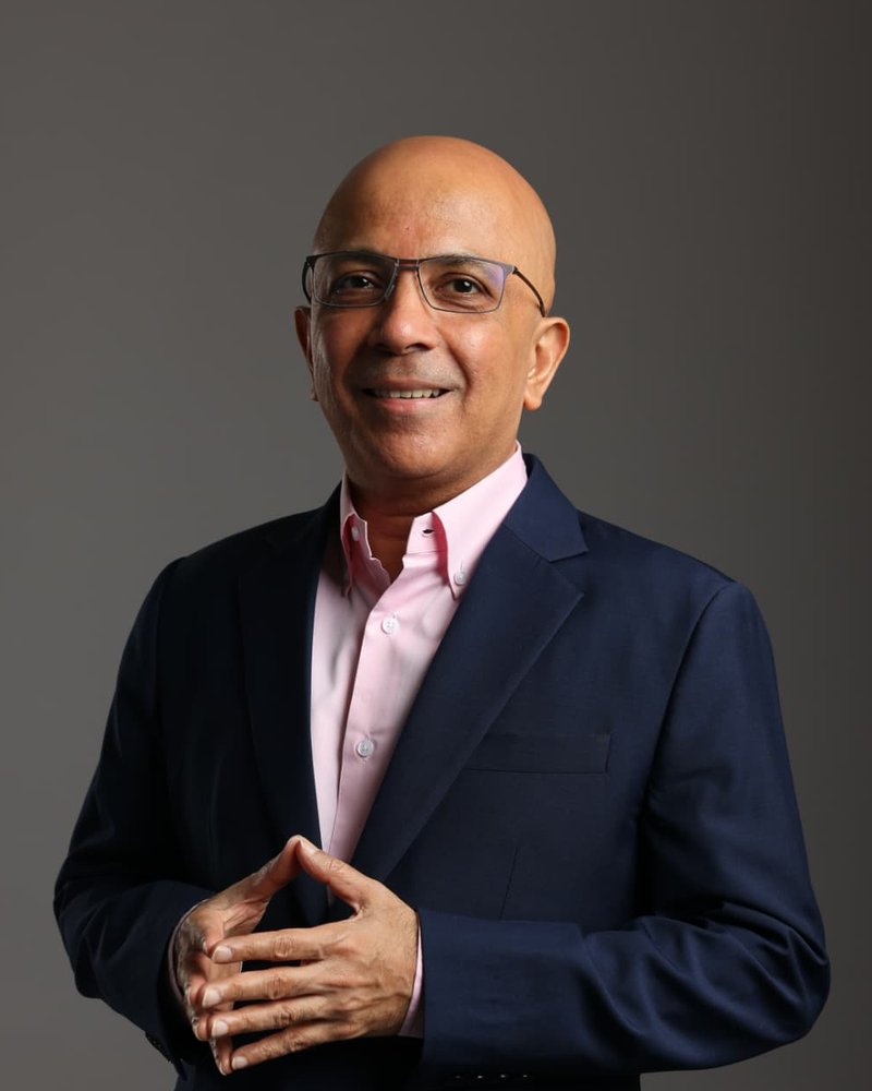 Portrait of Manoj Chugani, Co-Founder and Principal of ICL Partners, in a navy suit