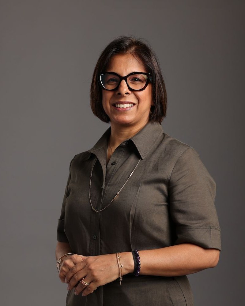 Portrait of Rianna Chugani, Co-Founder and Principal of ICL Partners, in an olive dress
